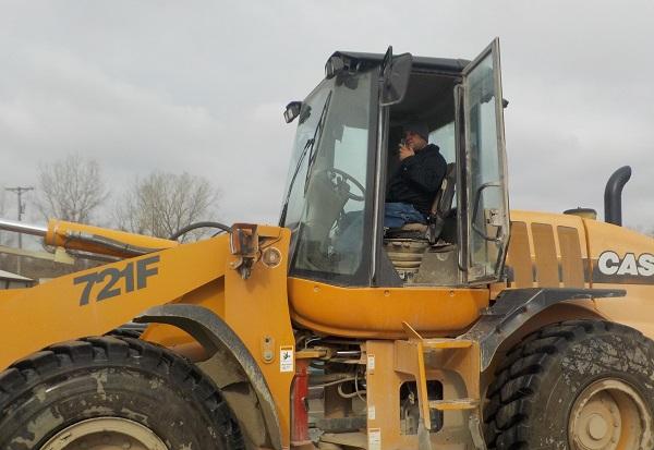 man in tractor with walkie talkie