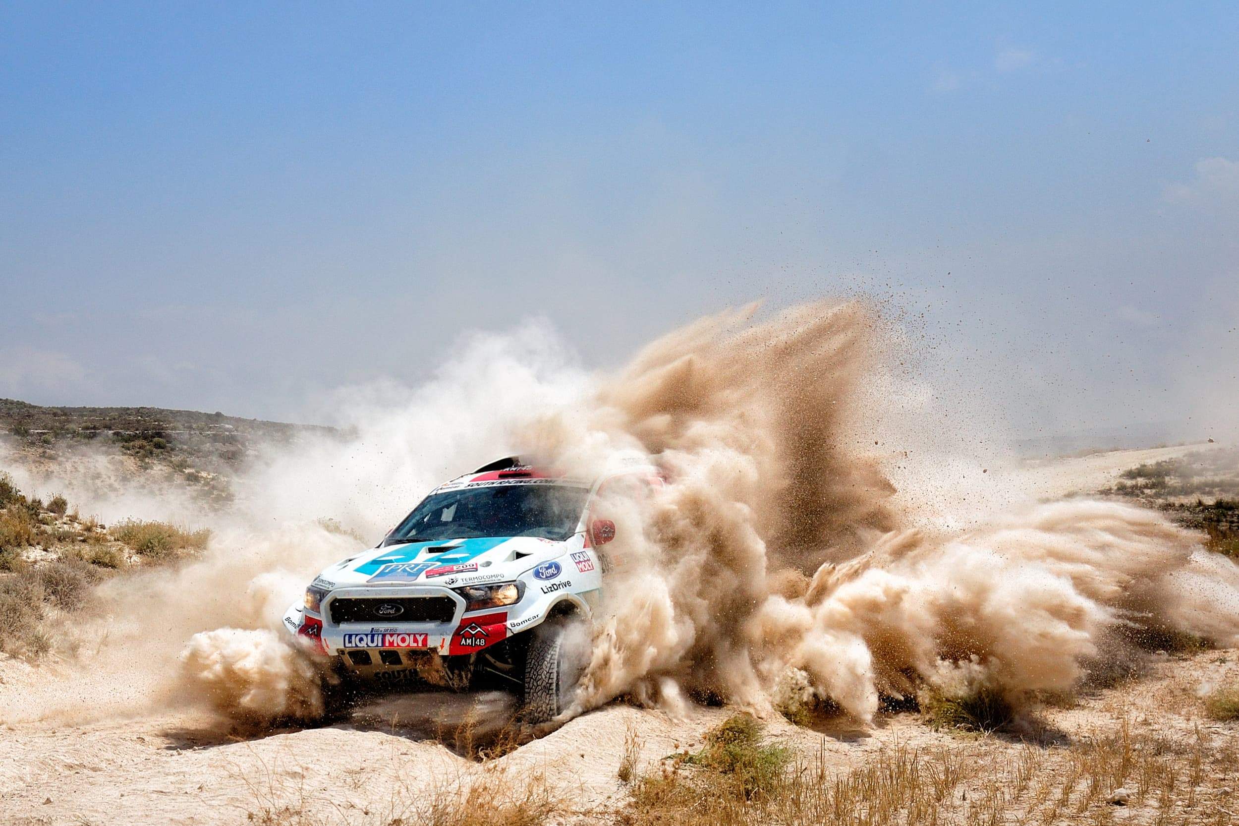 overland vehicle goes through sand