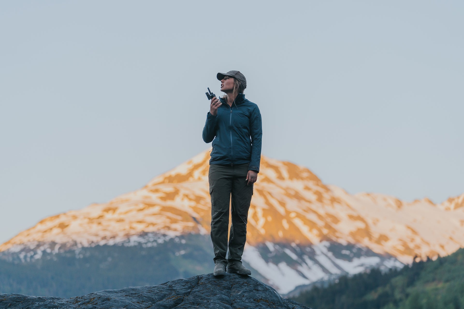 woman on mountain with walkie talkie
