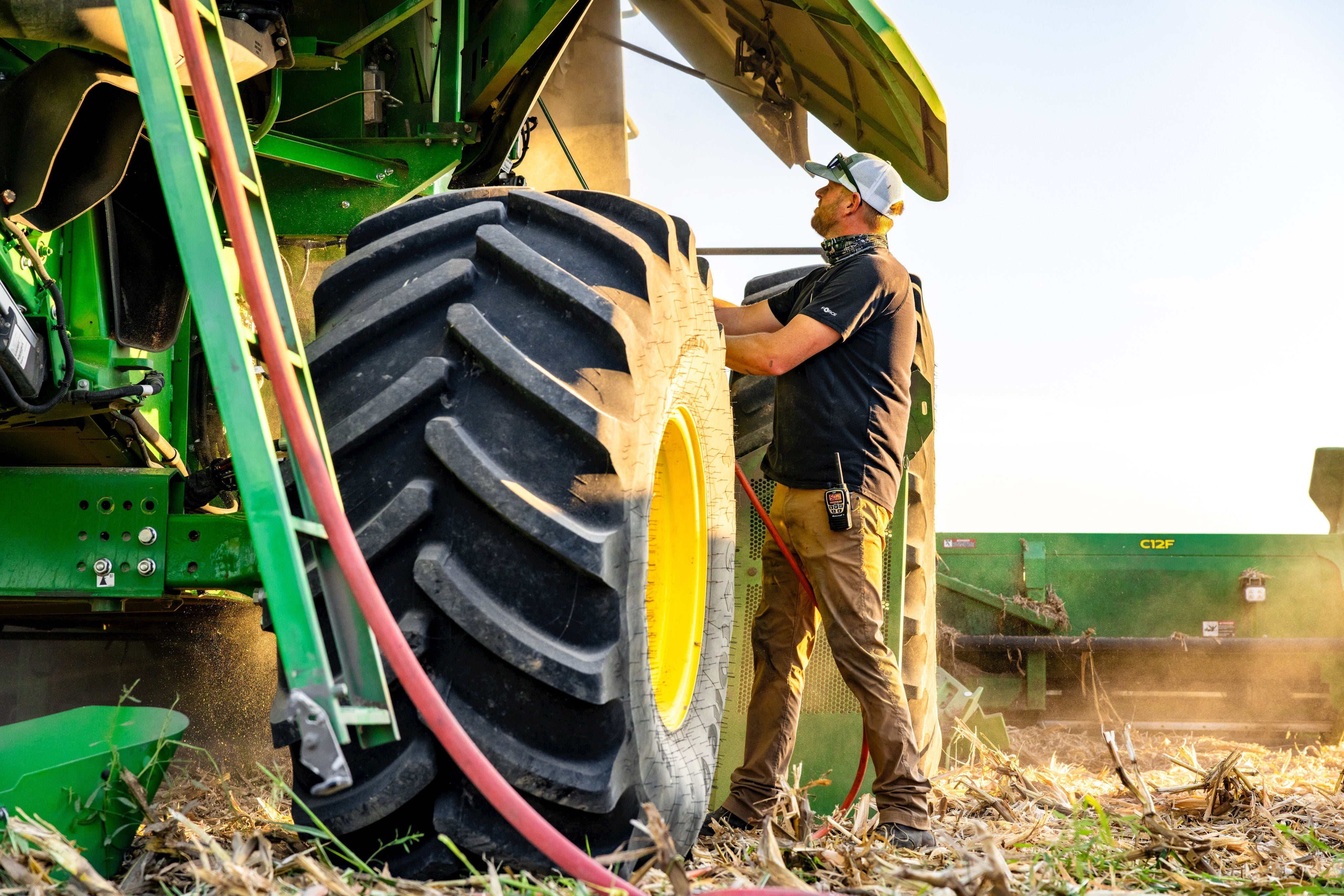 man stands by combine