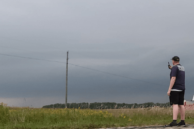man uses walkie talkie outside storm