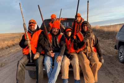 group of hunters hold guns