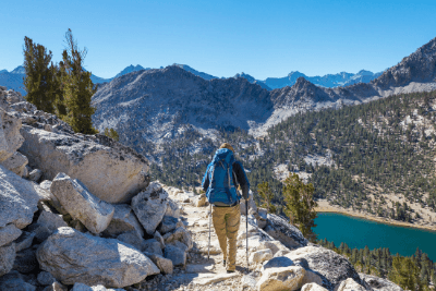 man hikes in mountains