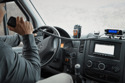 man holds MicroMobile microphone in van