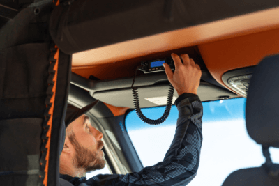 man turns radio dial in van