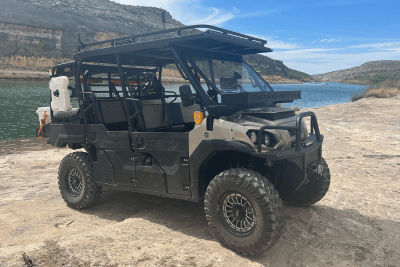 UTV next to water on top of rocks