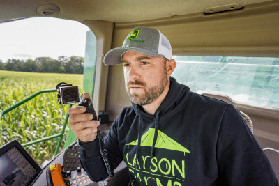 man in combine cab holds MicroMobile mic