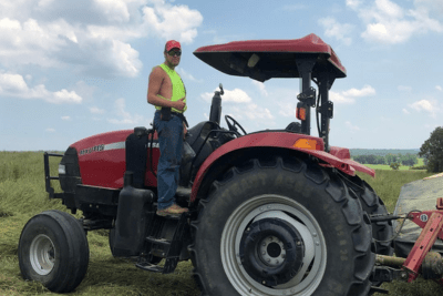 man stands on tractor
