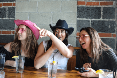 girls using walkie talkie at bar