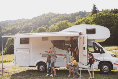 people stand outside RV