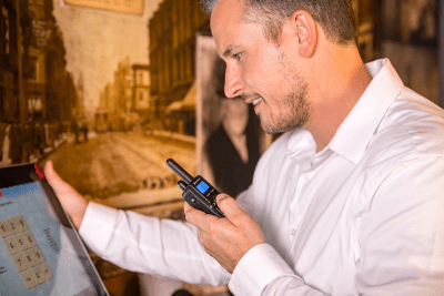 man holds business radio at POS system