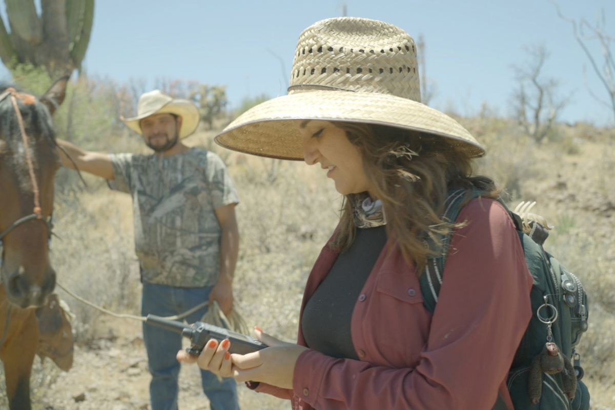 woman holds walkie talkie