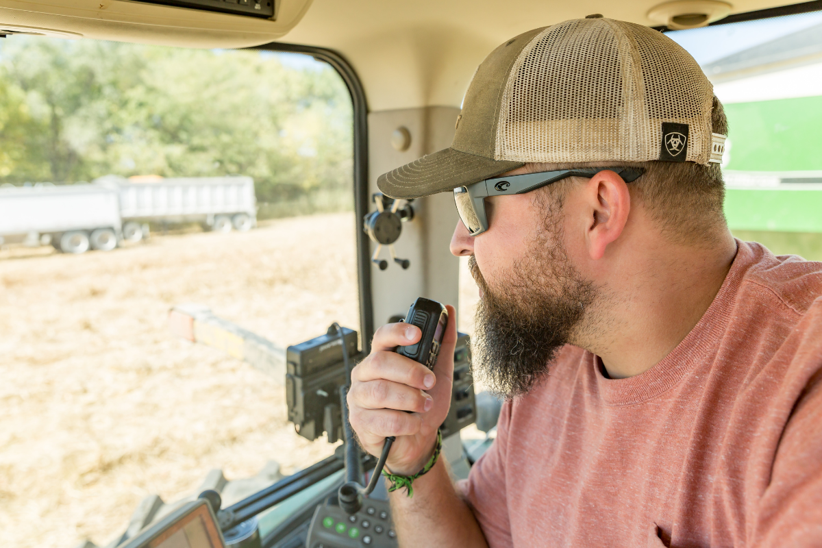 man uses radio in tractor vehicle