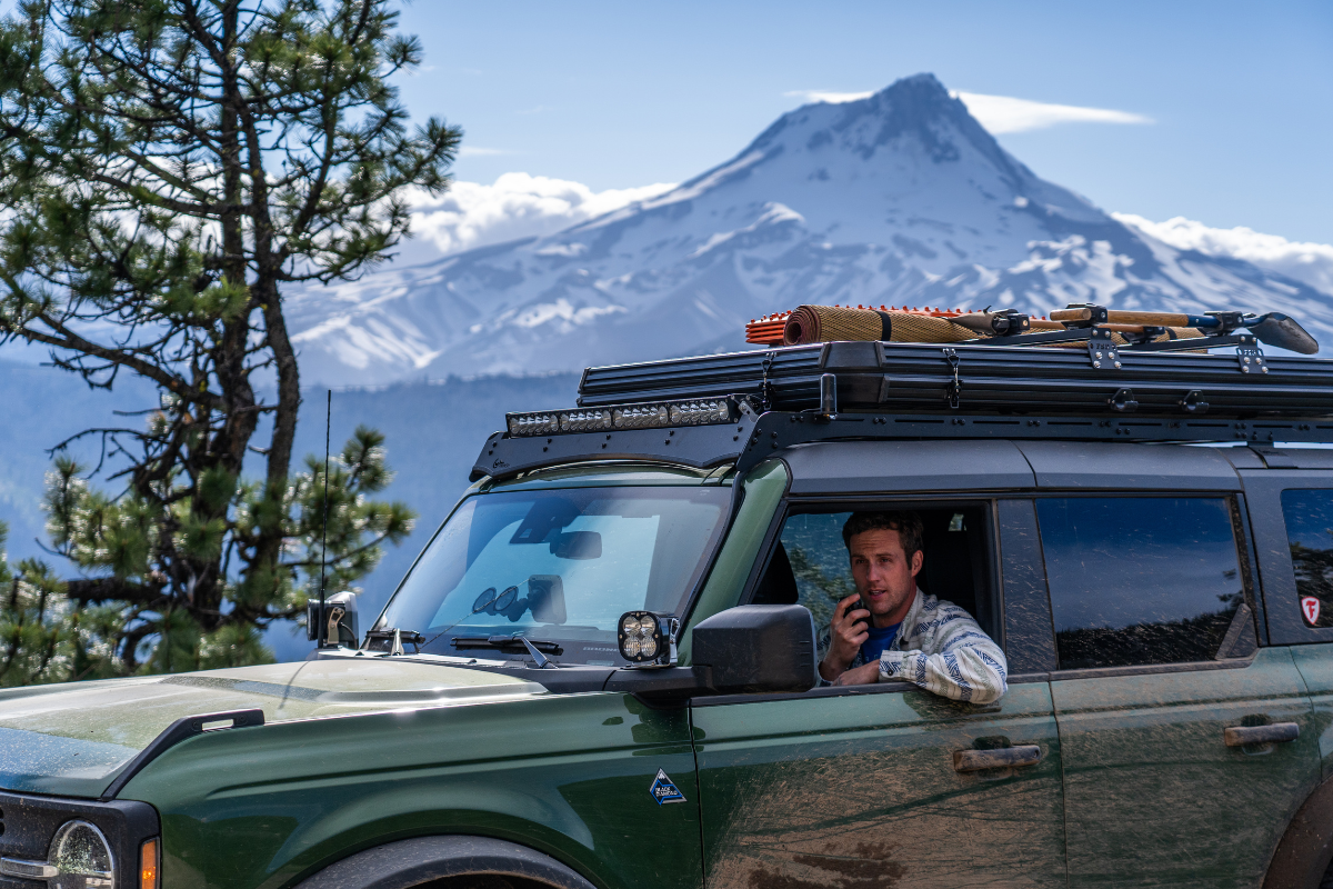 man in overlanding vehicle using radio