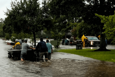 crews in flooded street