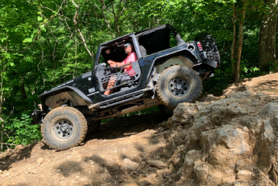 Jeep goes down dirt hill