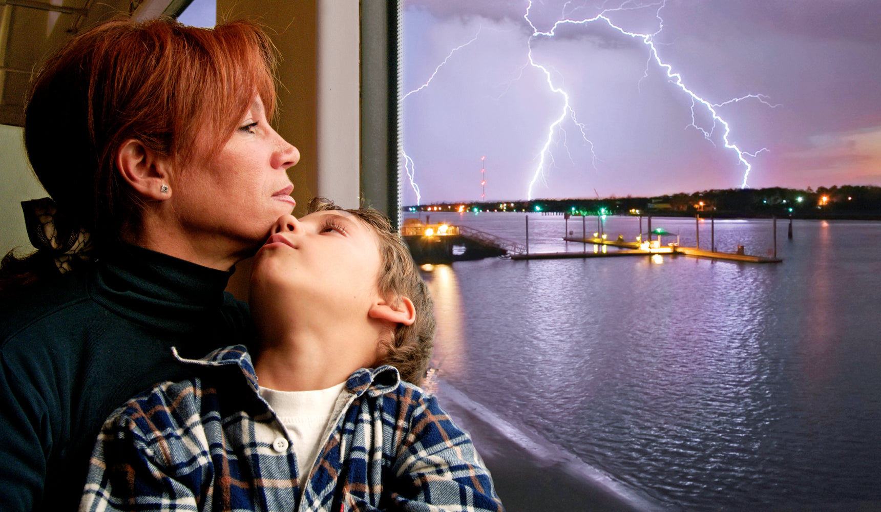 mon and child sitting by stormy window
