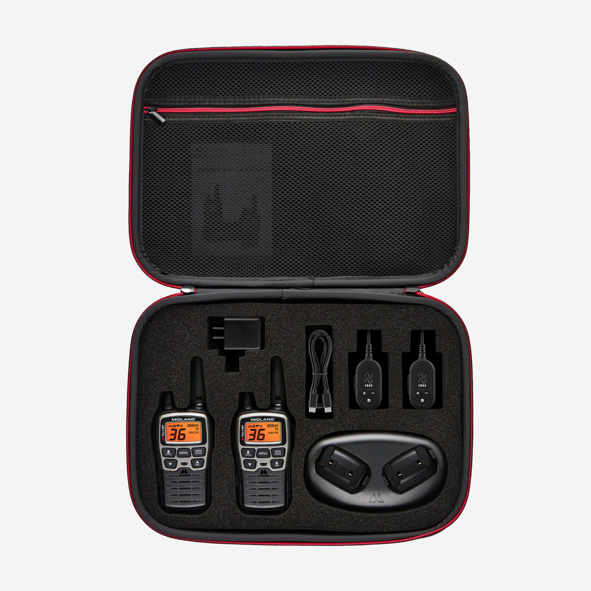 An open black and red zippered carrying case displaying a set of two black walkie-talkies, accessories including a USB cable, power adapter, and two small black devices, and a charging dock on a light gray background.
