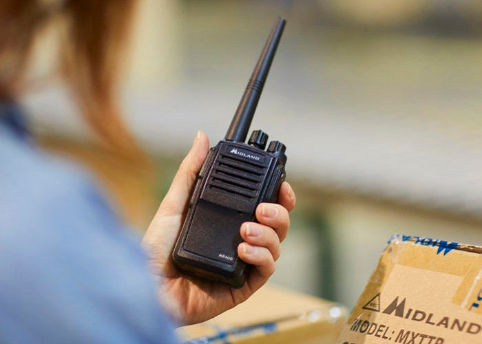 woman holds MB400 Business Radio in warehouse