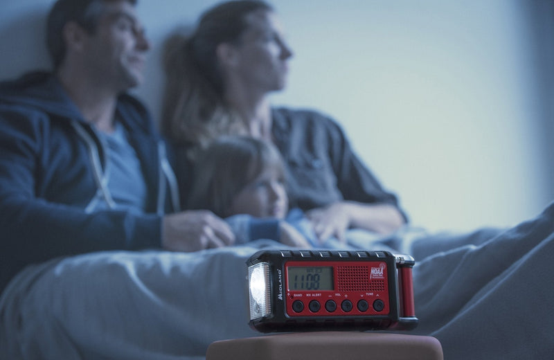family sits on floor with emergency radio