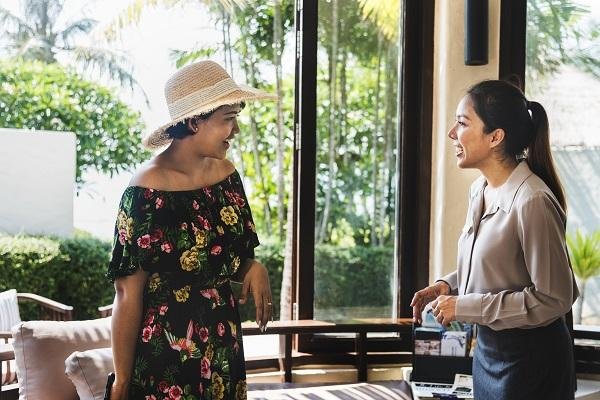 hotel staffer talks to guest