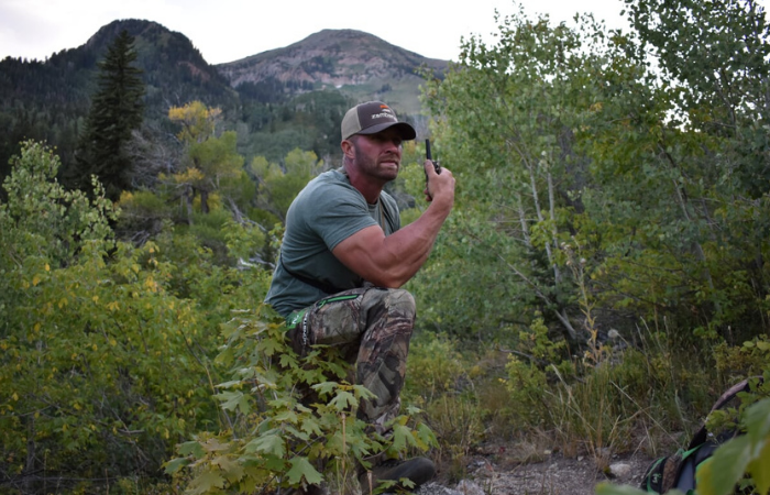 man uses walkie talkies in bushes