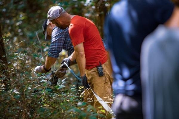 off-roaders with recovery straps in woods