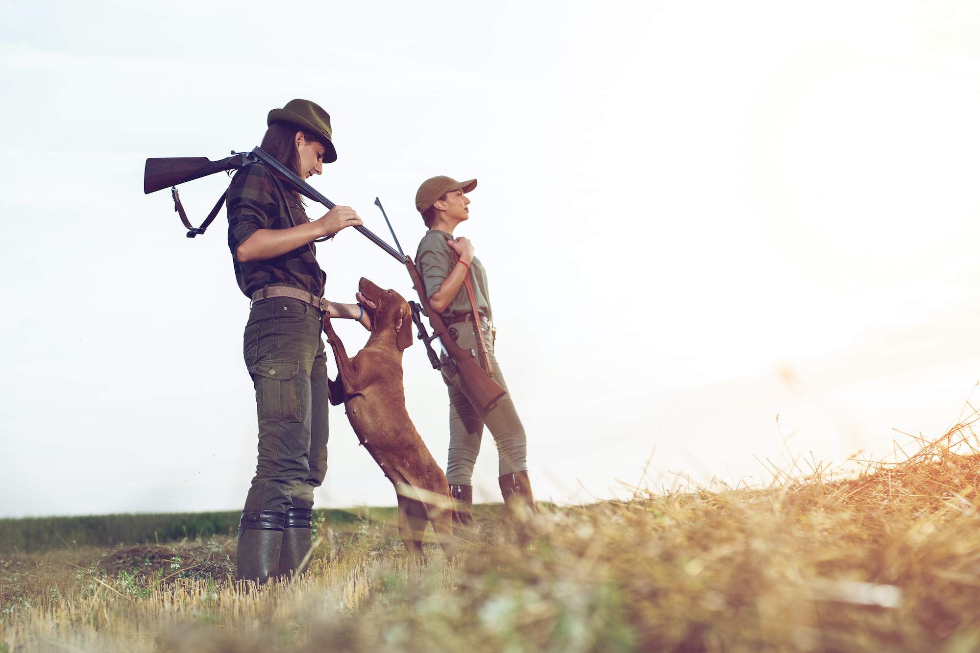 female hunters with dog