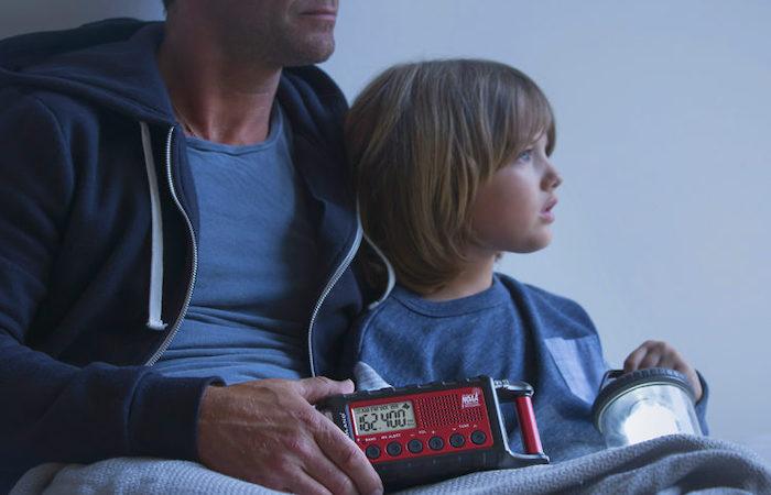 man and child hold emergency radio