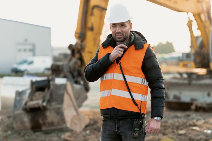 man uses radio at job site