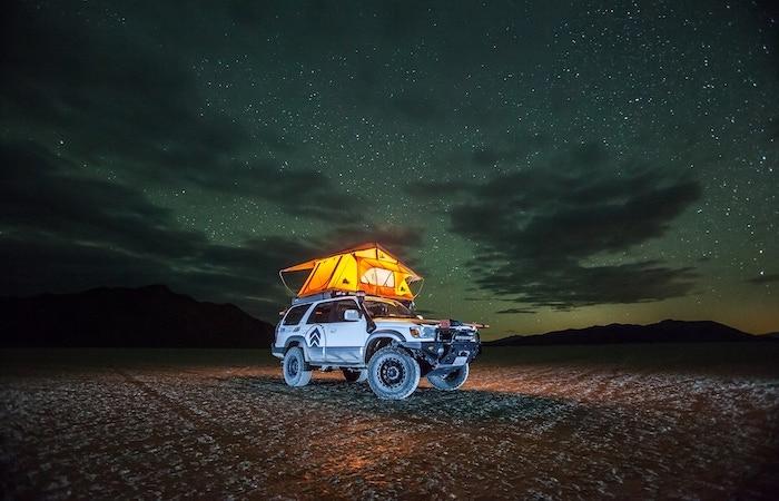 overlanding vehicle lit up at night