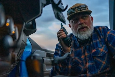 guy looks into his Jeep with his GXT67 Pro walkie talkie
