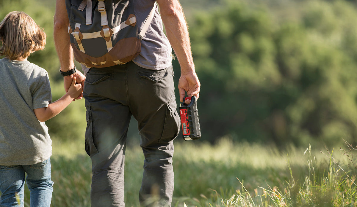father holds emergency radio in his hand