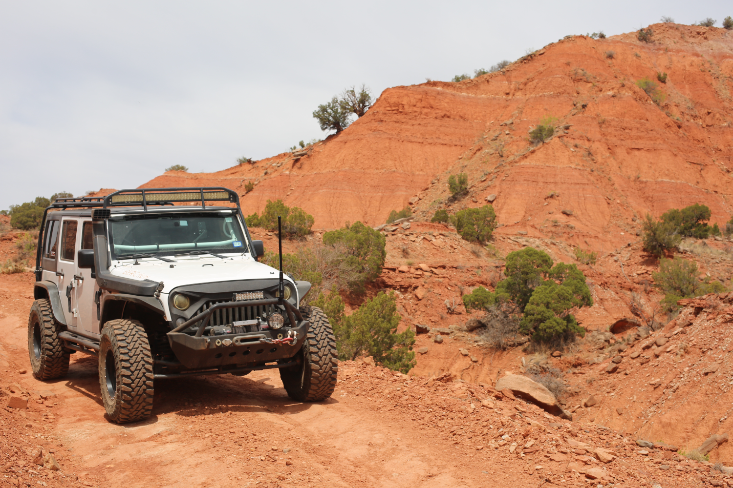Jeep in red dirt canyon