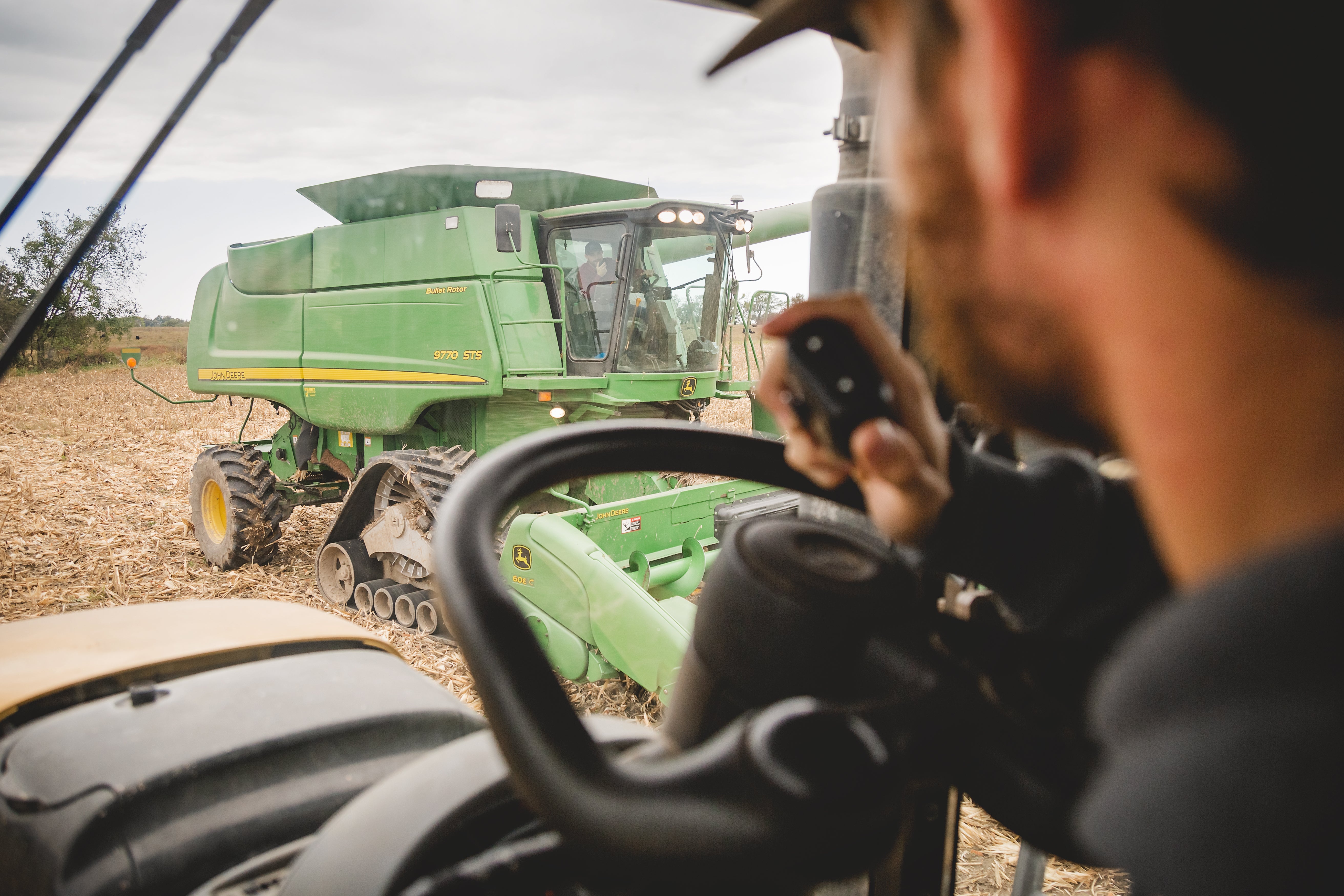 man in tractor uses microphone