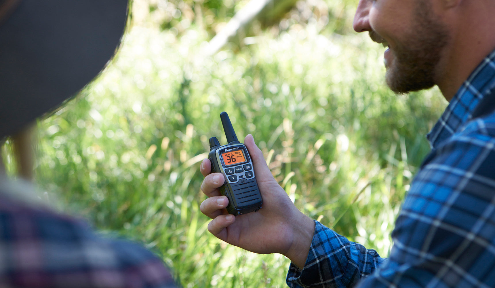 man holds walkie talkie