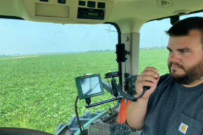 man uses MicroMobile mic in tractor cab