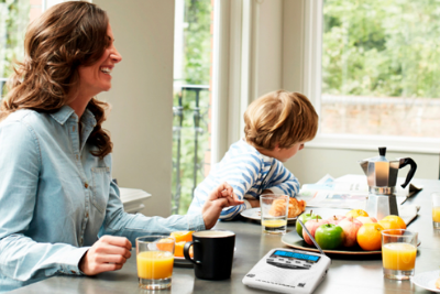 family sits at table with weather radio