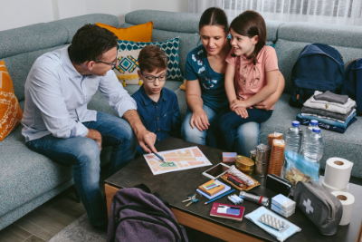 family sits around coffee table with supplies