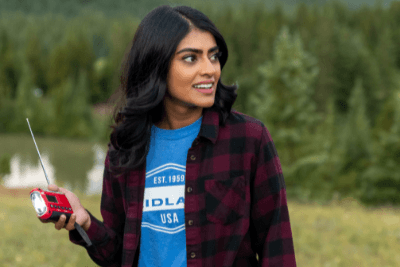 woman holds emergency radio