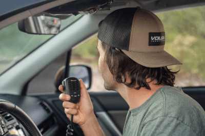 man holds MicroMobile mic in vehicle