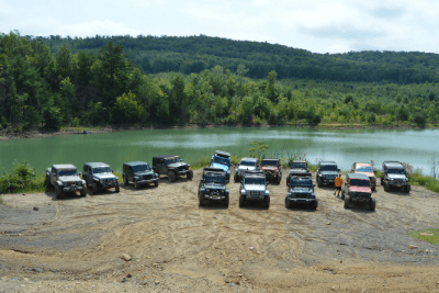 Jeeps line up by water