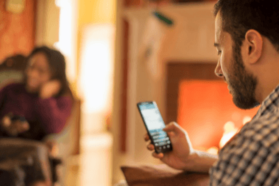 man looks at cell phone