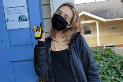 woman holds yellow walkie talkie