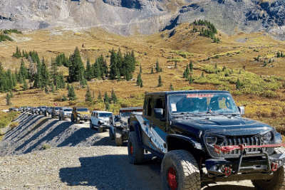 Jeeps come along bend of trail