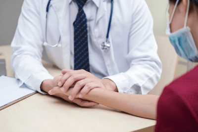 doctor holds patient hand
