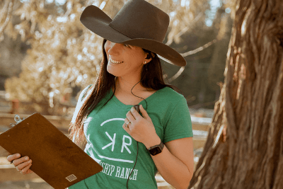 farmer holds clipboard and microphone for walkie talkie