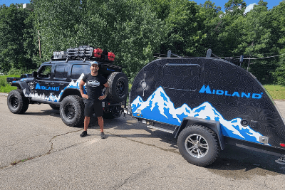 man in front of Midland jeep and trailer