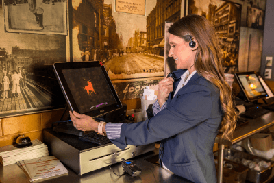 woman uses business radio at restaurant POS system