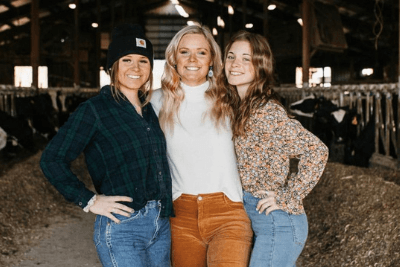 sisters pose in cattle barn